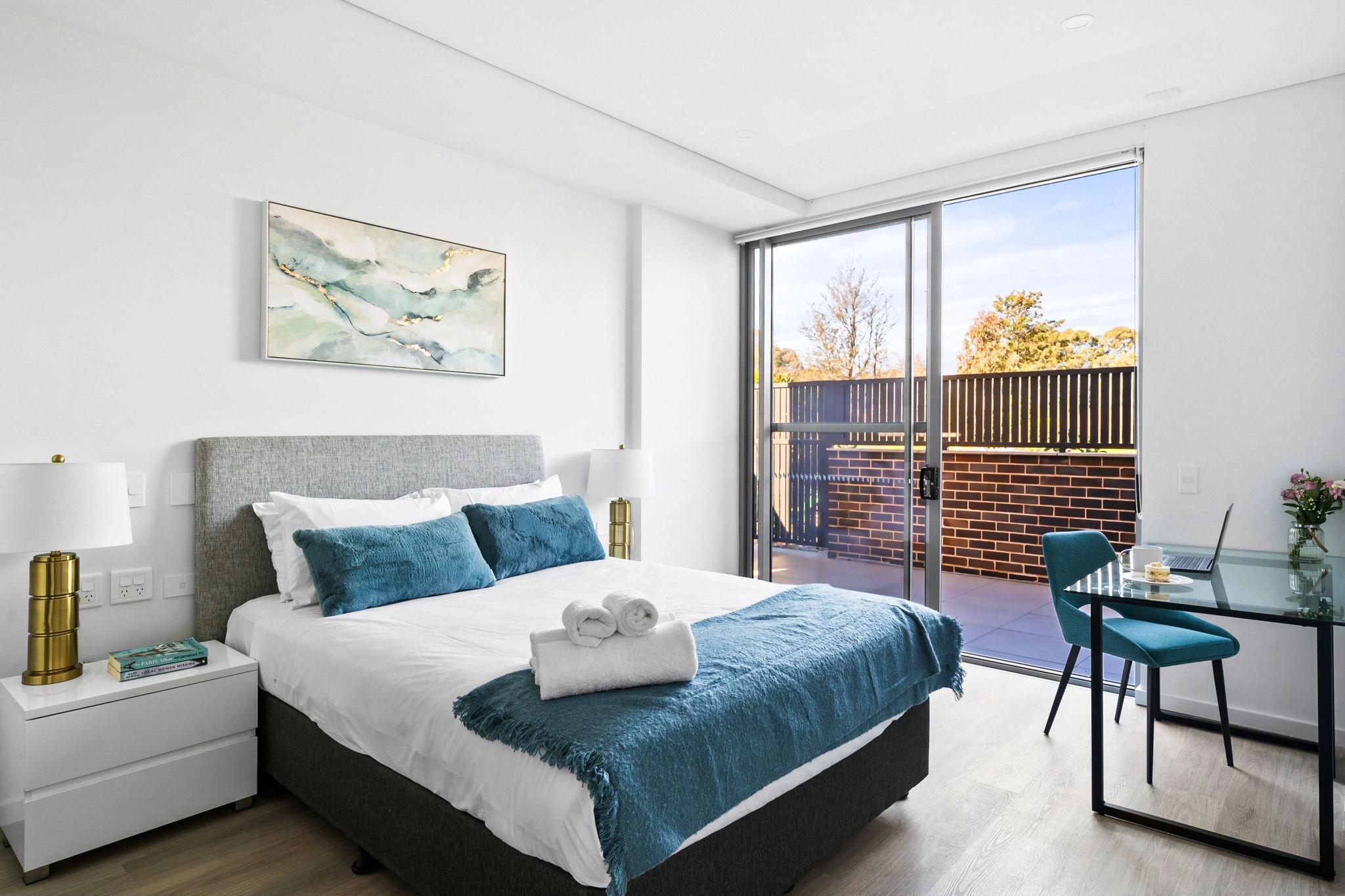 Modern property bedroom with a cosy bed, stylish decor, and a private balcony.